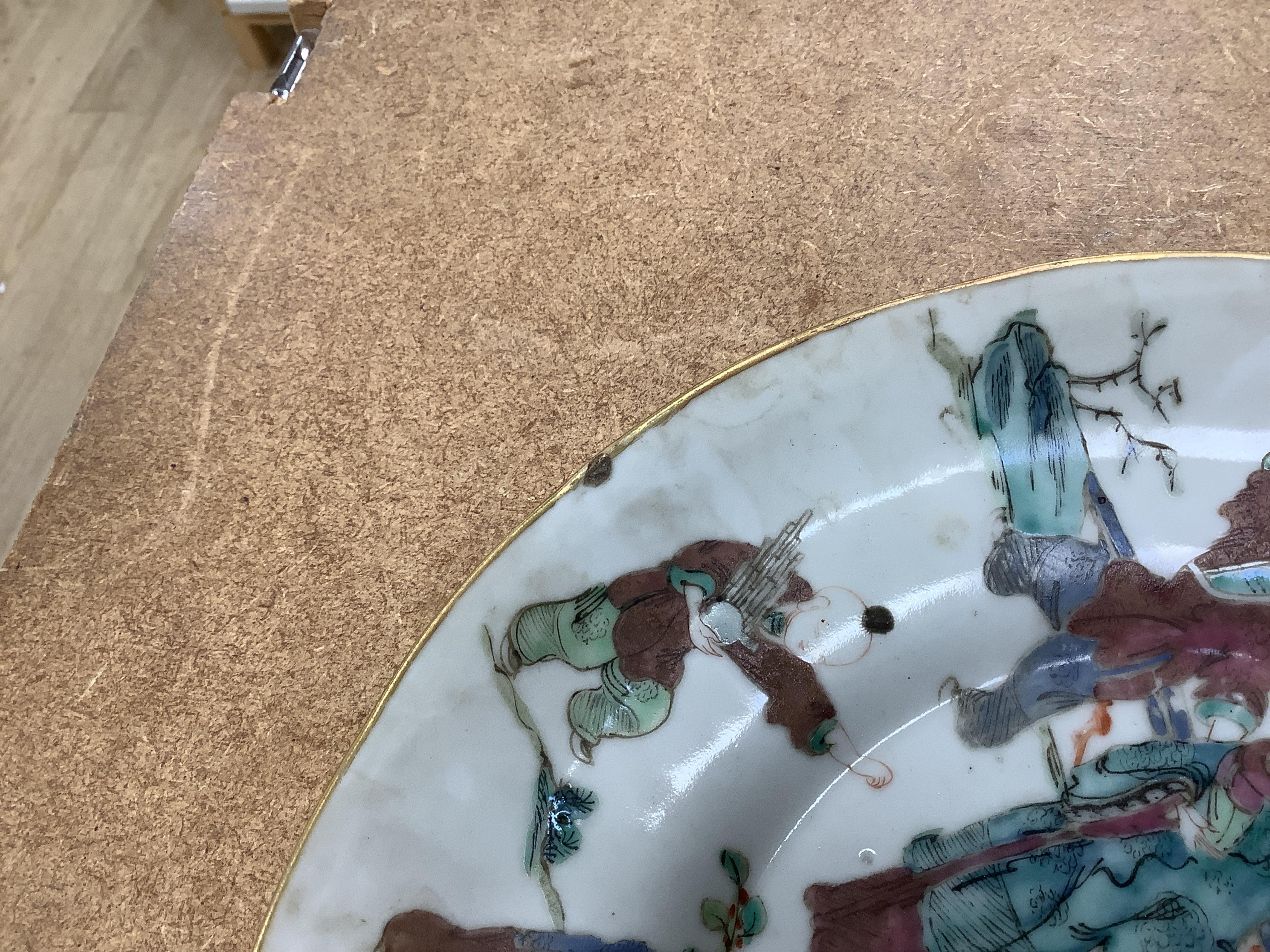A Chinese famille rose ‘boys’ saucer dish, Tongzhi seal mark and probably of the period (1862-1874) and an 18th century Chinese famille rose octagonal ‘cranes’ plate, dish 25cm diameter